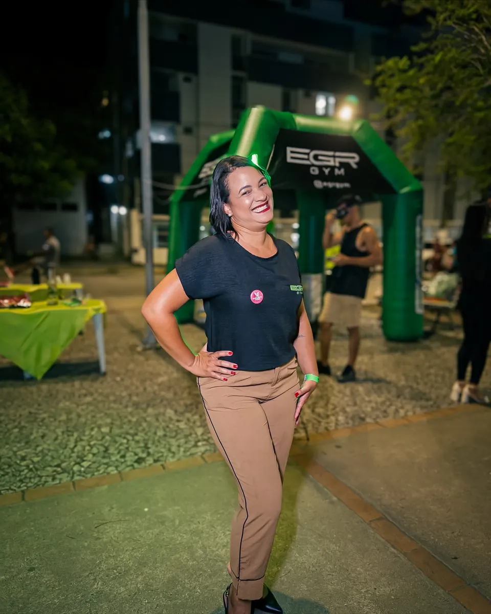Team and participants of EGR in Action, at night, in front of the EGR GYM entrance arch