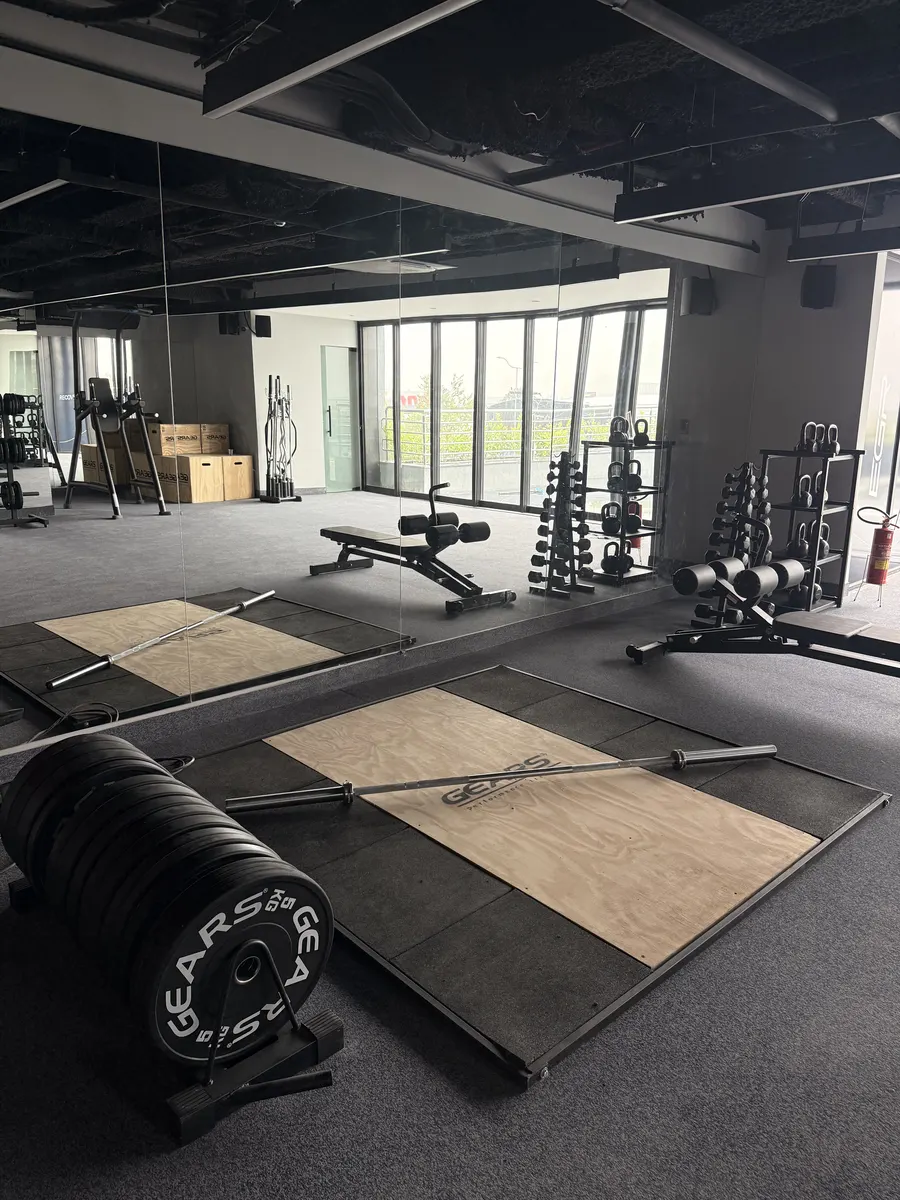 Área de treino livre com plataforma e anilhas